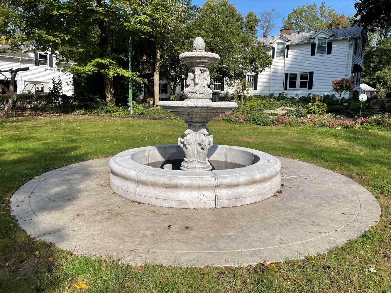Fountain and white house on the leafy Acadia Farms grounds