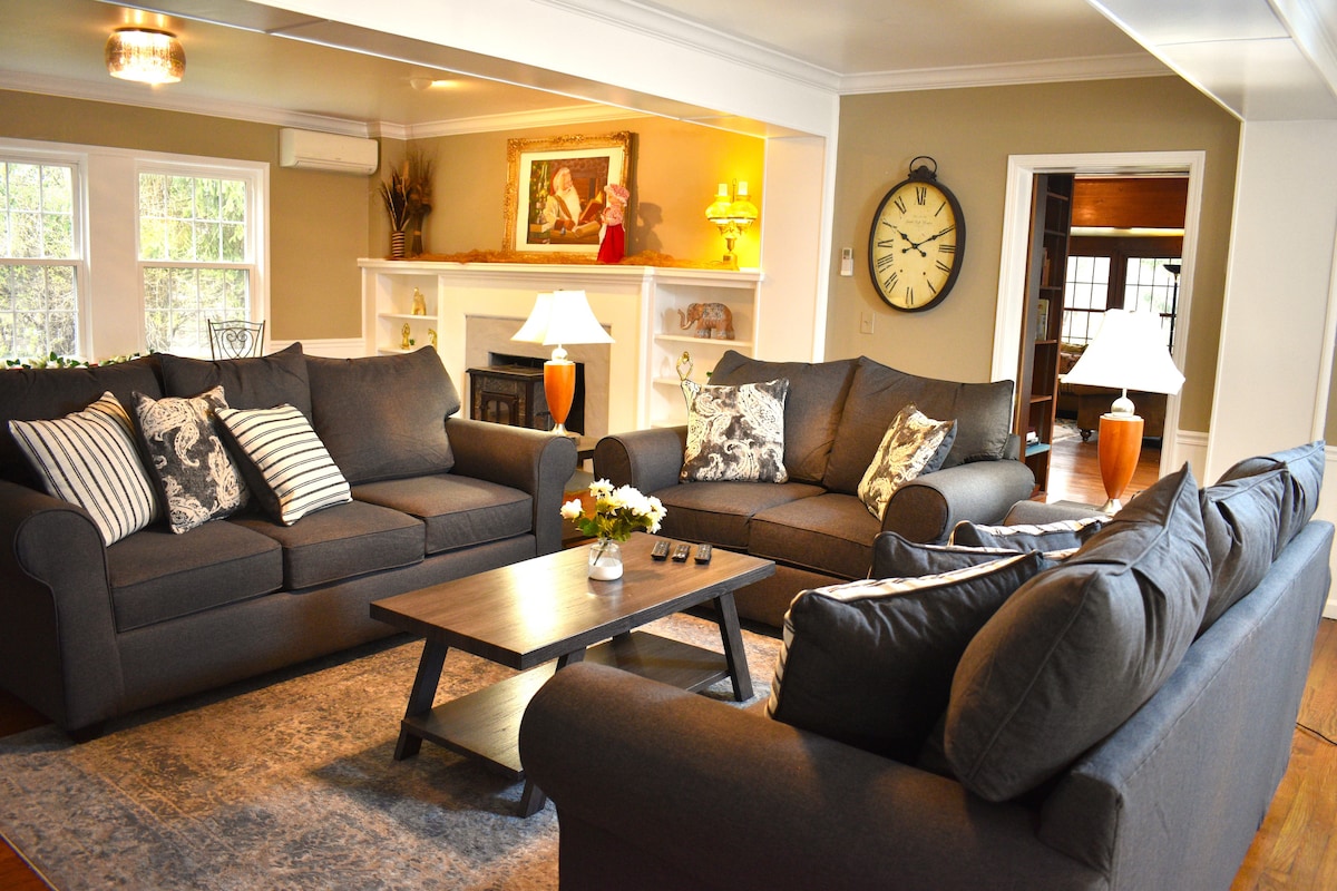 Living room with charcoal sofas and a fireplace in the Acadia Manor